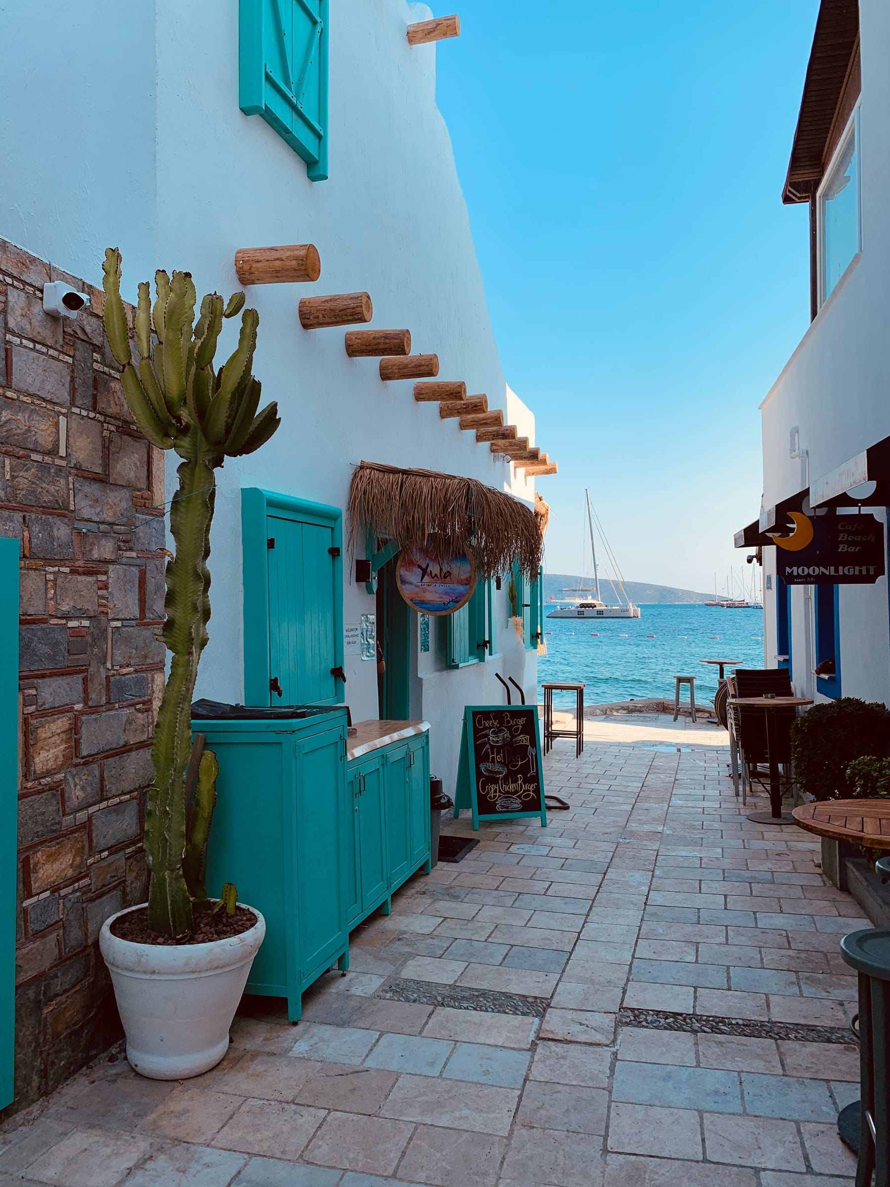 A narrow whitewashed street with flowers in Bodrum