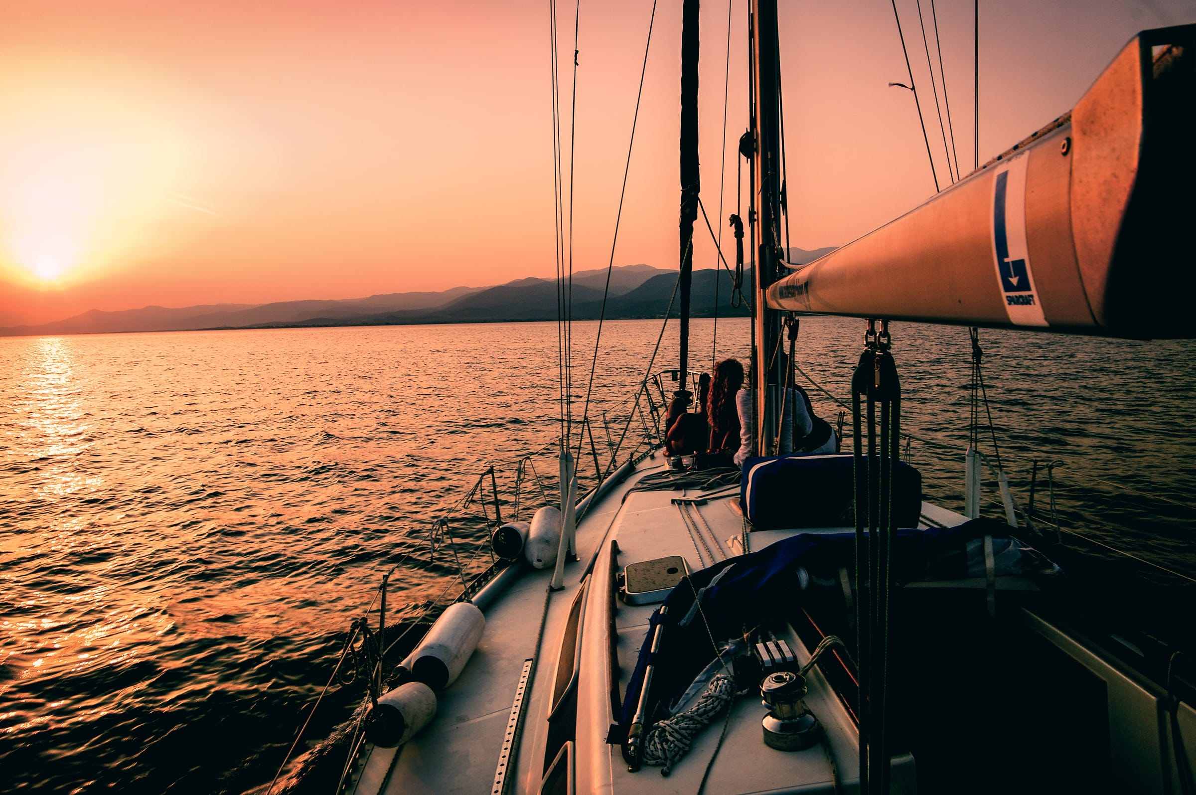 The deck of a sailboat at sunset